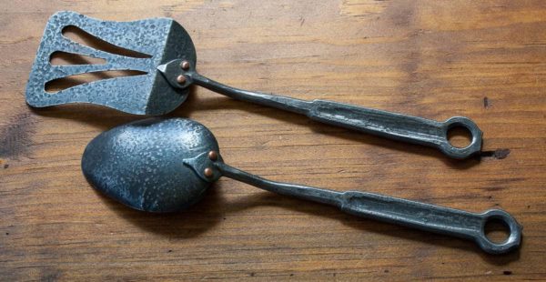 Hand forged spoon and spatula with steel handles, view of back