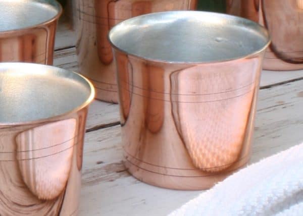 handmade copper tumblers with tin lining. Approximately 3" high, hold about 8-9 oz